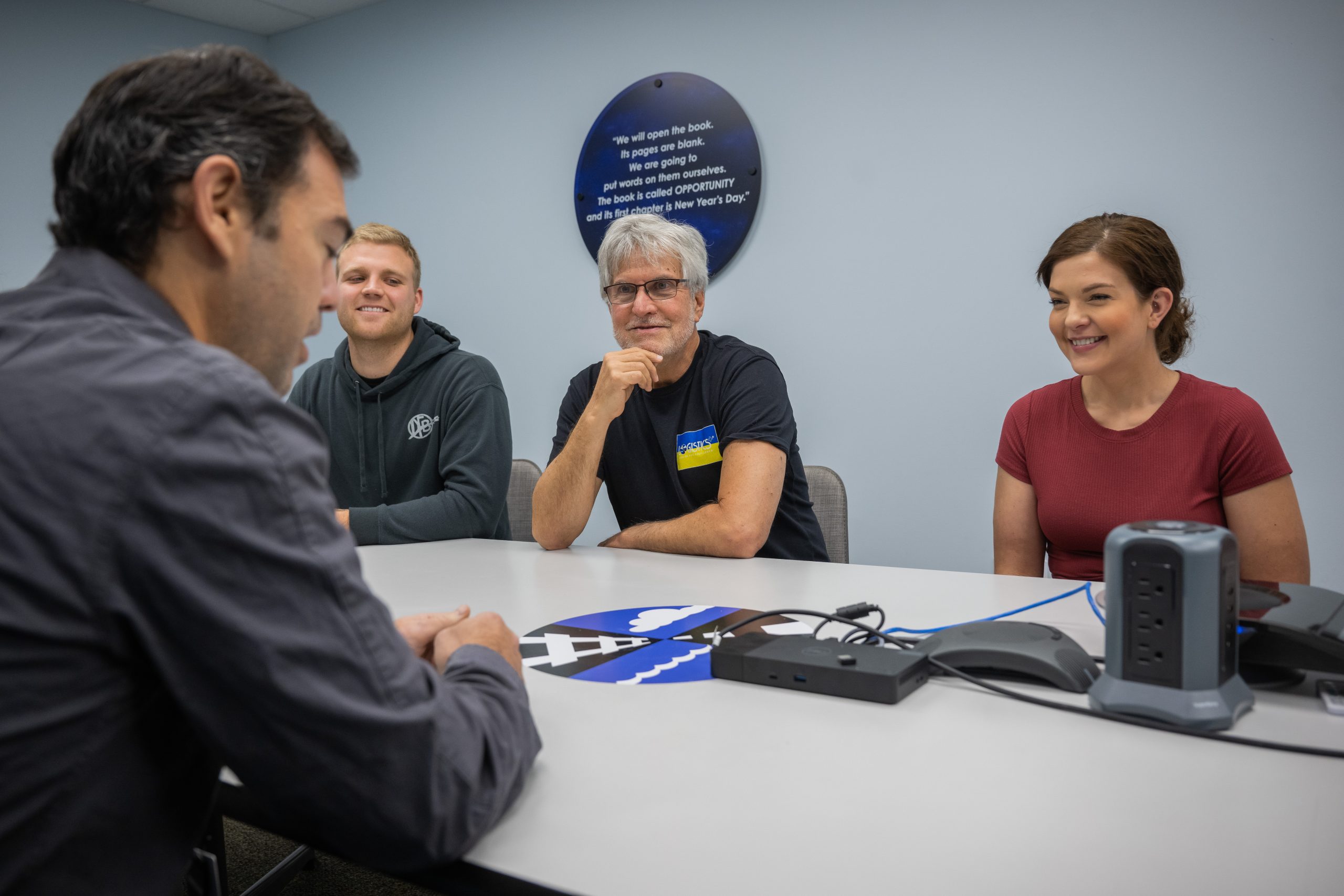 Jim Berlin (middle) meeting with Logistics Plus team members.